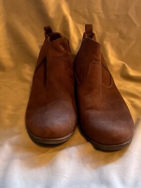 This is a faux brown suede short ankle boot with zippers on both sides